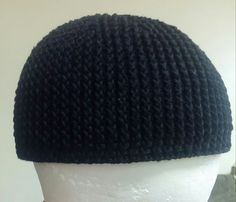 a white mannequin head wearing a black knitted hat