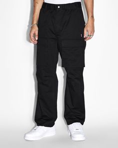 The Fugitive Elastic Cargo Pant Tru Black is a fresh take on our fugitive cargo designed with a fully elasticated waistband, zipper fly on the front and an internal drawcord. Made from premium cotton twill in a black colourway, this mid rise, relaxed fit cargo pant features an elasticated hem with toggle fasteners and frontward facing cargo pockets. This pant is detailed with diagonal cutaway pockets, back welt pockets and finished with a cross dollar print on the front, signature t-box, 4x4 embroidery and Ksubi branded hardware.

Cool machine wash with like colours, wash inside out, do not bleach, remove promptly after wash, do not wring, do not tumble dry, cool iron on reverse, do not iron directly onto prints or metal hardware, do not dry clean. The Fugitive, Cargo Pant, Cargo Pants Men, Black Colour, Welt Pocket, Cotton Twill, Cargo Pants, Mens Pants, Mid Rise