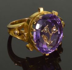 A great 14K gold amethyst diamond inlay ring of impressive design C.1860. Deep purple faceted amethyst inlayed with gold forming a branch with flowers accented with rose cut diamonds. The amethyst is 14 mm X 11 mm. The ring face is 17 mm X 15 mm. The size of the ring is 5 3/4. The are no hallmarks, tested 14K gold. Total weight is 5.3 grams. Very good antique condition commensurate with age. Amethyst has some minor scratches. One small piece of inlay on the branch is missing which practically do Gold Amethyst Rings With Rose Cut Diamonds, Vintage Diamond Amethyst Ring For Formal Occasions, Luxury Gold Amethyst Ring With Rose Cut Diamonds, Formal Amethyst Ring With Rose Cut Diamonds, Heirloom Purple Ring With Rose Cut Diamonds, Heirloom Amethyst Jewelry With Rose Cut Diamonds, Purple Rose Cut Diamond Rings In 14k Gold, Round Amethyst Ring With Rose Cut Diamonds, Amethyst Ring With Rose Cut Diamonds, Oval Shape