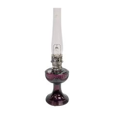 a purple glass and metal device with a light on it's top, in front of a white background