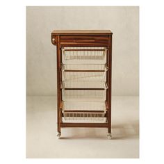 an old fashioned wooden cabinet with baskets on it's front and bottom shelves, against a white background