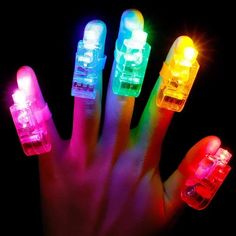 a person's hand with four different colored lights on it and their fingers in the air