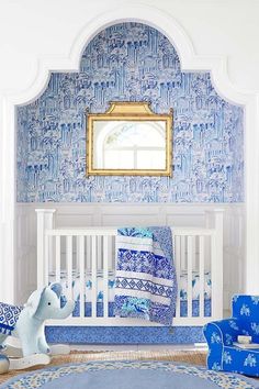 a baby's room with blue and white decor