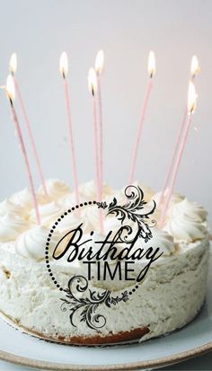 a birthday cake with white frosting and lit candles on it that says, birthday time