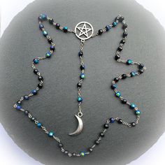 "Witchy Gothic Long Rosary Necklace.  Long Faceted Peacock Aurora Borealis Iridescent Coated Black Glass with Silver Pentacle and Crescent Moon. A wonderful dark Gothic inspired creation for Vintage Vixens, Goth Guys or Proud Pagans.  ✩Necklace Measurements and Materials✩ (all measurements are approximate) *72cm long (28 inches not including central drop), no clasp as it easily slips over your head *central drop including Pentacle and Crescent 15cm (6 inches) *the Pentacle 2.5cm (1 inch)- Stainl Black Adjustable Fantasy Necklace, Fantasy Style Adjustable Black Necklace, Fantasy Style Black Necklace, Adjustable Celestial Style Party Necklaces, Adjustable Celestial Necklace For Party, Necklace Measurements, Goth Guys, Rosary Necklace, Casting Jewelry