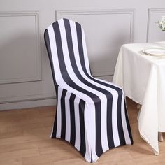 a black and white striped chair next to a table