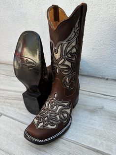 **DUE TO WIDE SQUARE TOE PLEASE ORDER HALF SIZE SMALLER** MADE IN MEXICO A true cowgirl boot, it features a genuine leather upper with fancy western embroidery. This boot utilizes an air mesh lining for excellent breathability without sacrificing quality, fit, or durability. This boots is sure to be one of your favorites, both in and out of the saddle. **DUE TO WIDE SQUARE TOE PLEASE ORDER HALF SIZE SMALLER** 1 1/2" heel height 11" shaft Western Glitter embroidery Lightweight, leather outsole Glitter Embroidery, Cute Cowgirl Boots, Cowboy Boots For Women, Western Embroidery, Brown Glitter, Western Shoes, Womens Cowgirl Boots, Cowgirl Boot, Embroidered Boots