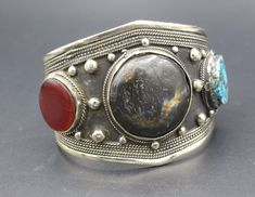 Vintage Afghan Turkmen cuff bracelet. Its %100 hand crafted adorable Labradorite stones compressed turquoise and carnelian stones with boho style cuff bracelet. Please do not hesitate to contact if you have any questions. Weight : 63.3 grams Inner circumference : 15cm ( 5.9" ) Width : 5cm ( 2" ) Shipping & Estimated Delivery Time With Turkish Registered Post, Destination CountryStandard Shipping (business days) United States          15-20  Europe7-15 Asia15-25  Australia15-20 Brazil & South Ame Artisan Cuff Bracelet As Festival Gift, Artisan Bangle Cuff Bracelet For Festivals, Heavy Bohemian Bangle Cuff Bracelet, Handmade Spiritual Bangle For Festivals, Spiritual Festival Bangle Cuff Bracelet, Handmade Spiritual Cuff Bracelet For Festivals, Traditional Cuff Bracelet Bangle With Natural Stones, Traditional Adjustable Cuff Bracelet With Natural Stones, Unique Festival Cuff Bangle Bracelet