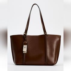 New With Tag Zara 2024 Collection Tote Bag. Shoulder Strap. Pendant Detail. Interior Maxi Pocket. Magnetic Closure. Height Length Width: 11.6 14.4 4.7 Inches(29.5 36.5 12 Cm) Brown | 6071/410 Outer Shell 100% Polyurethane Lining 65% Polyester Zara Brown Bag, Zara Tote Bag, Zara Tote Bags, Zara Bags, Brown Bag, Brown Bags, 2024 Collection, Bag Shoulder, Magnetic Closure