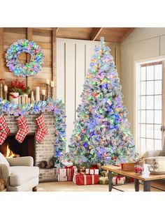 a decorated christmas tree in front of a fireplace with stockings and wreaths on it