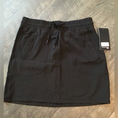 This Skirt Is In New Condition. Side Pockets Have Hidden Zipper .Elastic Waist With Draw String Body Is 88%Polyester And 12% Spandex. Black Sporty Mini Skirt For Sports, Sporty Black Pleated Skirt, Sporty Black Relaxed Skort, Sporty Black Mini Skirt, Loose Fit Nylon Casual Skirt, Casual Solid Nylon Skirt, Casual Nylon Skirt With Relaxed Fit, Black Nylon Skort For Sports, Casual Black Nylon Skort