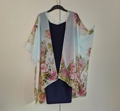 "This versatile kimono cardigan can be worn as a beach cover-up or with a  dress or camisole. Suitable for daywear or eveningwear, the perfect addition to any wardrobe.  Ideal for holidays and travelling, even backpacking as it takes up nearly no room in your travel bag and is light. Kimono Cardigan: - Wide Sleeves - Draping perfectly - Light weight sheer delicate soft fabric - One size fits most - Floaty fabric - Light and breathable - V neck style at the back *Please note the dress is not incl Floral Print Shawl Kimono For Spring, Spring Floral Print Shawl Kimono, Spring Shawl Kimono With Floral Print, Summer Bohemian Cape Kaftan, Bohemian Summer Kaftan With Cape Style, Bohemian Summer Cape Kaftan, Bohemian Summer Kaftan With Cape, Bohemian Cape Kaftan For Summer, One-size Spring Kaftan Tunic