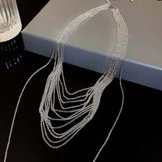 ✦ Transform your wardrobe with this Multistrand Silver Tassel Chain Necklace. Accessorize with this elegant yet simple piece for a bold and daring look. Perfect for a night out, this necklace will take your outfit to the next level. Despite the absence of diamonds, this eye-catching piece will make you shine at any party! ----------- DETAILS ----------- - Color: Silver - Materials: Brass - Necklace Length: 42.3cm - SKU: HN2699