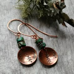 A small copper disc that I've hand stamped with a leafy branch design and then domed slightly dangles below 2 african turquoise nuggets. The copper discs have been given an antiqued finish. These measure just shy of 2 inches from the tops of the hand formed and forged ear wires. I have a version similar to these in sterling silver that can be found here: https://www.etsy.com/listing/788766284/southwestern-jewelry-turquoise-earrings?ref=shop_home_active_1 These will ship quickly~gift boxed pretti Necklace Leather Cord, Stamped Metal Jewelry, Turquoise Jewelry Set, Unique Dangle Earrings, Metal Stamped Jewelry, Bijoux Fil Aluminium, Silverware Jewelry, Necklace Leather, Jewerly Making