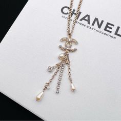 Authentic Chanel Pearl Crystal Chain Cc Multi Strand Necklace. Light Gold Color, Cc Pendant With Iridescent Crystals. Multi Strand With Free Form Faux Pearl And Crystals. Comes With The Original Box And Pouch. Like New Condition. Made In France. Size: 16-23 Inch Adjustable. Pendant Is 3.25*0.9 Inch. Luxury White Chain Necklace With Adjustable Chain, Luxury White Clavicle Chain Necklace, Elegant Pendant Chain Necklace With Logo Charm, Elegant White Jewelry With Logo Charm, Elegant White Necklace With Logo Charm, Elegant White Crystal Chain Necklace, Luxury Pearl Chain Necklace, Chanel Pearl Necklace, Chanel Pendant