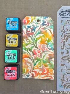 four ink pads, one with an ornate design and the other with different colored inks