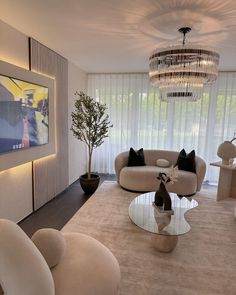 a living room filled with furniture and a chandelier