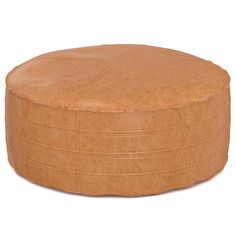 a round leather ottoman sitting on top of a white floor