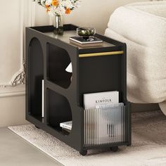 a black side table with magazines on it