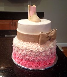 a cake decorated with pink, white and brown ruffles