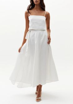 Our beloved Lola Wrap Skirt is perfectly flattering and elegant. This chic 100% linen skirt rests on the hip and flows down for a femenine silhouette. It features a tied closure with elastic waistband on the back for a perfectly adjustable fit, and on the back it has a central belt loop so that the tie stays in place. It is slightly longer on the back for a more dramatic and flirty effect. Size & Fit: Model is wearing size S/M Model’s measurements: Height: 5’ 10’’ / 179 cm Bust: 32.7’’ / 83 cm W Relaxed Linen Maxi Skirt For Vacation, Long Linen Skirt For Vacation, Linen Long Skirt For Vacation, Vacation Long Linen Skirt, Vacation Wide-leg Linen Maxi Skirt, Fitted Linen Maxi Skirt For The Beach, Linen Flowy Skirt For Vacation, Flowy Linen Skirt For Vacation, Elegant Full Skirt Bottoms For Vacation