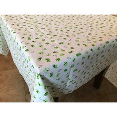 a table covered in green and white polka dot paper with small trees on the top