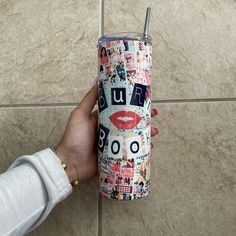 a person holding a cup with stickers all over it