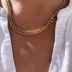 This gold plated Cuban link chain necklace has a simple but bold appeal. Crafted from stainless steel and plated with a thick 18k gold layer, the chain has tighter interlocking links than a classic curb chain. The necklace makes an ideal base for mix and matching with other chains and pendant necklaces or can be worn solo for an understated look.  ▪️Gold plated stainless steel ▪️7mm wide chain ▪️Lobater clasp ▪️Choose your length ▪️The neckla will be presented in attractive Scraffs packaging Everyday Cuban Link Necklace With Cable Chain, Minimalist Gold Plated Cuban Link Chain Necklace, Everyday Gold Plated Curb Chain Necklace, Chic Necklaces With Chunky Cuban Link Chain, Chic Cuban Link Chunky Chain Necklace, Trendy Gold Curb Chain Necklace, Trendy Cuban Link Gold Chain Necklace, Gold Plated Curb Chain Link Necklace, Chic Curb Chain Choker Necklace