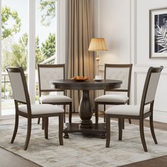 a dining room table with four chairs around it