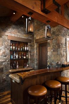 a stone bar with stools in front of it