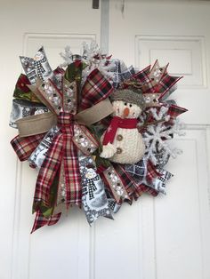 a snowman wreath hanging on the front door