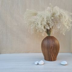 a vase filled with white flowers sitting on top of a table