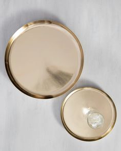 two round brass plates sitting next to each other