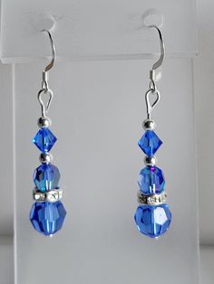 This pair of dangle earrings is made from Sterling Silver beads and findings.  It contains a 4mm, 6mm and 8mm Sapphire (blue) Swarovski crystals. These earrings also feature clear ab Czech crystal, silver-plated rondelle beads. Custom Orders are always welcome! Nickel-free Blue Crystal Earrings, Nickel Free Blue Crystal Earrings, Providence Ri, Czech Crystal, Wire Earrings, Sapphire Blue, Jewelry Inspo, Sterling Silver Bead, Silver Beads