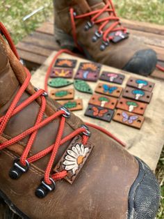 These little beauties are hand tooled and hand painted, made from full grain cowhide leather. Each one is hand crafted in Indiana.    Shoes are one of the last frontiers as far as accessories! Let your shoes & boots stand out with my new Lacelet boot charms.       Each Purchase includes 1 Barrett/Lacelet!  If you'd like a pair, 2 purchases are necessary, (you can choose a matching/unmatched set)    Choose between many different designs, & choose between 5 background colors-Black, Brown, Mahogany, Tan, & Orange.  (Ignore background color on Large Leaf)  These are all hand carved/hand painted, please allow slight variations in color and artwork. (These are not stamped with one large stamp, each design is cut in by hand, & tooled with a series of small leather tools) process video on my insta Jewelry Mushroom, Boot Charms, Diy Sy, Shoes Charms, Diy Leather Projects, Leather Craft Projects, Hiking Accessories, Handmade Boot, Leather Diy Crafts