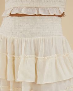 Featuring a smocked pull-on waistband, this mini skirt comes in lightweight, breathable crinkle fabric with ruffled tiers. Smocked waist Pull on style Tiered ruffle skirt Lightweight 80% Viscose 20% Nylon Hand wash in cool water. Do not bleach. Line dry in shade. Iron cool. The Smocked Ruffle Mini Skirt is styled with the Scooped Smocked Tank. Smocked Skirt, Rachel Parcell, Crinkle Fabric, Ruffle Mini Skirt, Tiered Ruffle Skirt, Ruffle Skirt, Smocking, Mini Skirt, Bleach