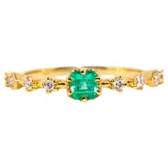 Crafted in 18 carat yellow gold, this delightful contemporary ring holds an alluring natural green emerald flanked by eight glistening round brilliant cut diamonds shimmering in unison. Her name is The Ruri Ring, the perfect ring for stacking with other beloved gems and jewels or wearing alone. The Ruri Ring Gemstone Details The bright green square emerald cut emerald is 0.31 carats and measures approximately 4.00x3.87x3.2 millimetres. The round brilliant cut diamonds total 0.20 carats and F colour and VS clarity grades. Ring Size M (Australia and UK sizing) or 6 1/4 (US and Canada) The Ruri Ring can be resized prior to shipping upon request. Resizing is complimentary up or down three sizes or please message us for a quote if more sizes are needed. Great to Know The Ruri Ring belongs to ou Green Emerald Ring With Single Cut Diamonds For Promise, Emerald Green Promise Ring With Single Cut Diamonds, Luxury Green Emerald Ring With Single Cut Diamonds, Fine Jewelry Green Emerald Ring With Single Cut Diamonds, Yellow Gold Emerald-cut Ring With Single Cut Diamonds, Green Diamond Ring With Single Cut Emerald Shape, Green Emerald Cut Diamond Ring With Single Cut Diamonds, Green Emerald Cut Diamond Ring With Rose Cut Diamonds, Luxury Green Emerald Ring With Rose Cut Diamonds