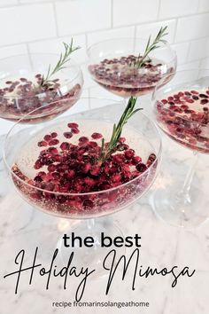 three glasses filled with cranberry sauce and garnished with rosemary sprigs