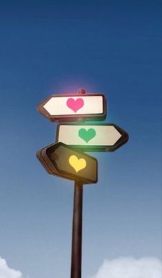 a street sign with two hearts painted on it's sides and the sky in the background