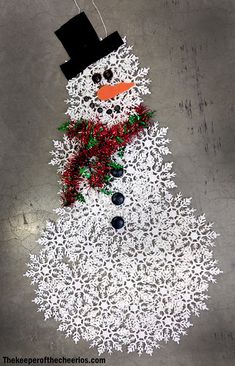 a snowman made out of paper on the ground