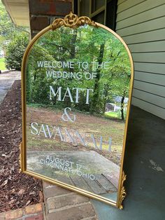 a mirror on the side of a house that says welcome to the wedding of matt and savannah