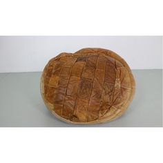 a round bread basket sitting on top of a table