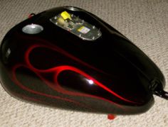 a close up of a computer mouse on the floor with its light turned red and black