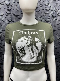 This is an Anthrax cropped forest green screen printed short sleeved top. This has the Anthrax Image screen printed on the front. 57% Cotton/ 38% polyester/ 5% spandex These are handmade screenprinted and slightly vary from the photo. Please feel free to email me any questions. Thanks for looking. I do not do exchanges and I do not take returns unless the item is damaged. I thoroughly check each item before it is shipped out. The seller is not responsible for any lost or stolen packages. Punk Graphic Print Short Sleeve Crop Top, Punk Style Graphic Print Crop Top With Short Sleeves, Summer Band Merch Cropped T-shirt, Fitted Green Crop Top With Graphic Print, Alternative Cropped Streetwear Tops, Summer Band Merch Cropped T-shirt With Short Sleeves, Band Merch Cropped T-shirt For Summer, Alternative Cropped Tops For Streetwear, Green Crop Top For Streetwear In Spring