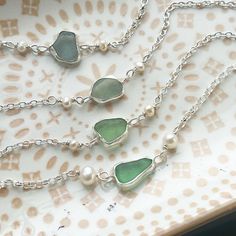 A beautiful pieces of sea-tumbled sea glass, found by me on one of my local Cornish beaches, which I have cleaned, and set in fine silver, so that you can take a piece of the Cornish beach with you wherever you go 💙I've added some pretty white, freshwater seed pearl links either side of the sea glass piece, and the sea glass will stay on top (where you want it), because the handmade recycled silver heart pebble charm positioned at the clasp acts as a counter weight - beautiful and functional   I am happy to take commissions and if you have your own sea glass you would like me to make something with, please message me and I we can work together to create your special piece of jewellery.  The length of all the bracelets pictured is 19cm/7.5in, however if you need a bigger or smaller size I Handmade Sea Glass Bracelet As Gift, Handmade Sea Glass Bracelet For Gift, Cornish Beaches, Pearls Bracelet, Sea Glass Bracelet, Silver Heart Bracelet, Glass Bracelet, Recycled Silver, Seed Pearl