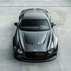 a black sports car parked on top of a parking lot