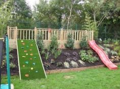 a backyard with a slide and artificial grass