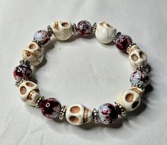 This bracelet is adjustable and stretchy for maximum comfort. Casual Adjustable Skull Beaded Bracelets, Casual Halloween Skull Jewelry, Casual Skull Jewelry For Halloween, Adjustable Red Beaded Bracelets For Halloween, Casual Halloween Jewelry Gift, Handmade Casual Skull Bracelet, Casual Handmade Skull Bracelets, Handmade Casual Skull Bracelets, White Adjustable Jewelry For Halloween