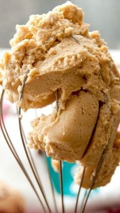 a scoop of ice cream is being held by a wire