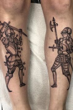 two men with tattoos on their legs holding swords and shields, standing next to each other